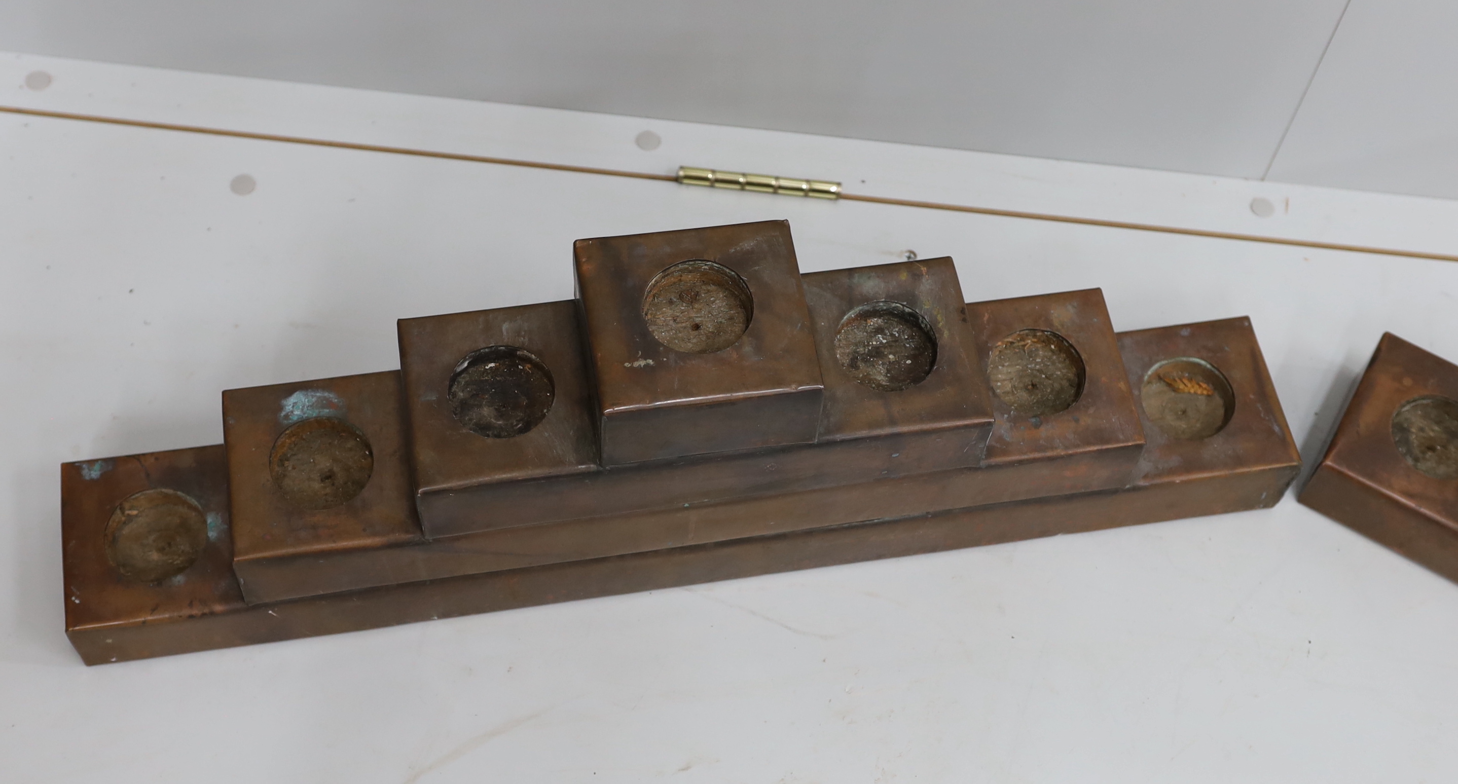 A pair of copper mounted candle holders, width 72cm, height 23cm